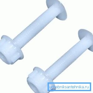 Na fotografiji - plastični vijci i navrtka za pričvršćivanje WC šolje u WC. Na fotografiji - plastični vijci i navrtka za pričvršćivanje WC šolje u WC.